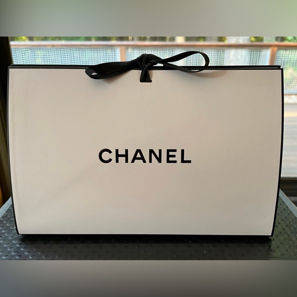 Chanel small gift bag with white shredded confetti.